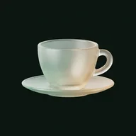 A frosted glass tea cup on a saucer